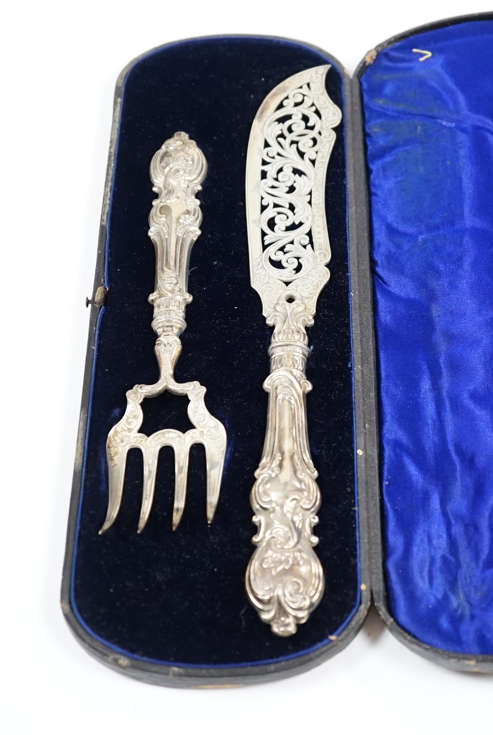 A cased pair of Victorian silver fish servers, maker H&I, Birmingham, 1863, knife 32.1cm. Condition - fair